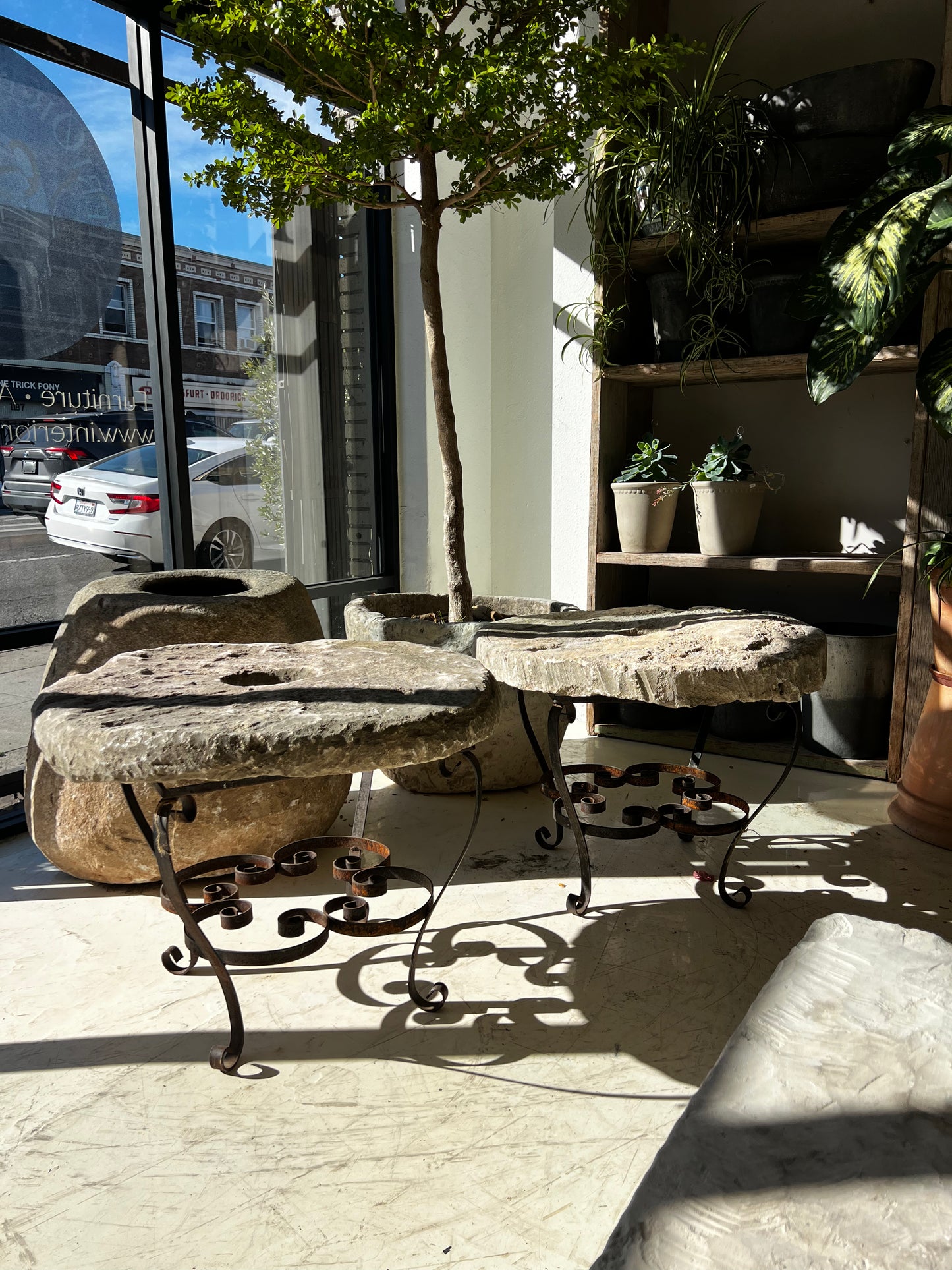 Side tables, limestone top and iron base 